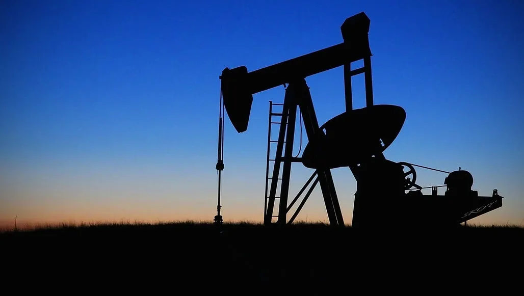 Pumpjack at an oil field at dusk